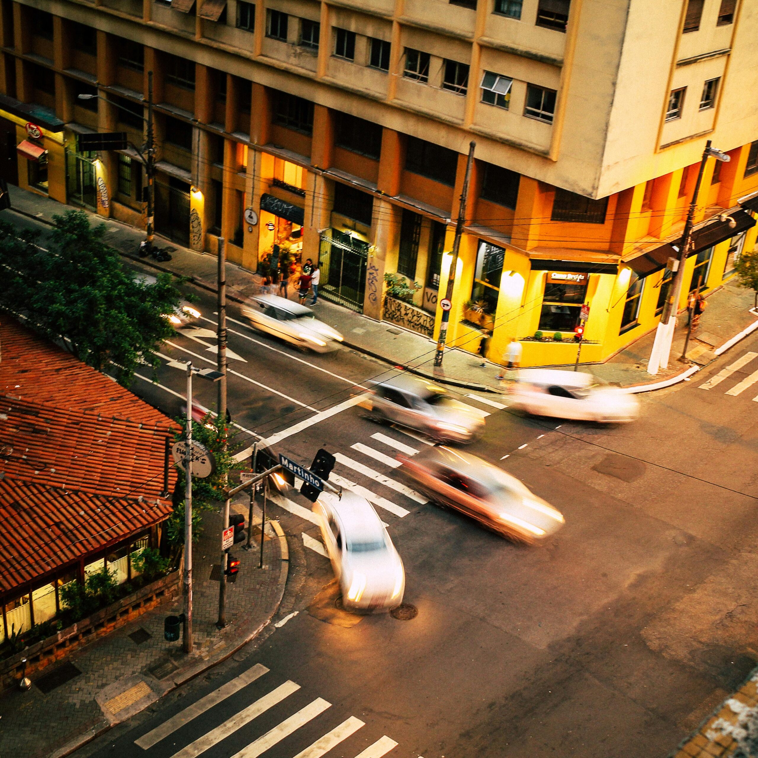 Captivating aerial shot of bustling São Paulo city street with blurred motion cars at dusk.